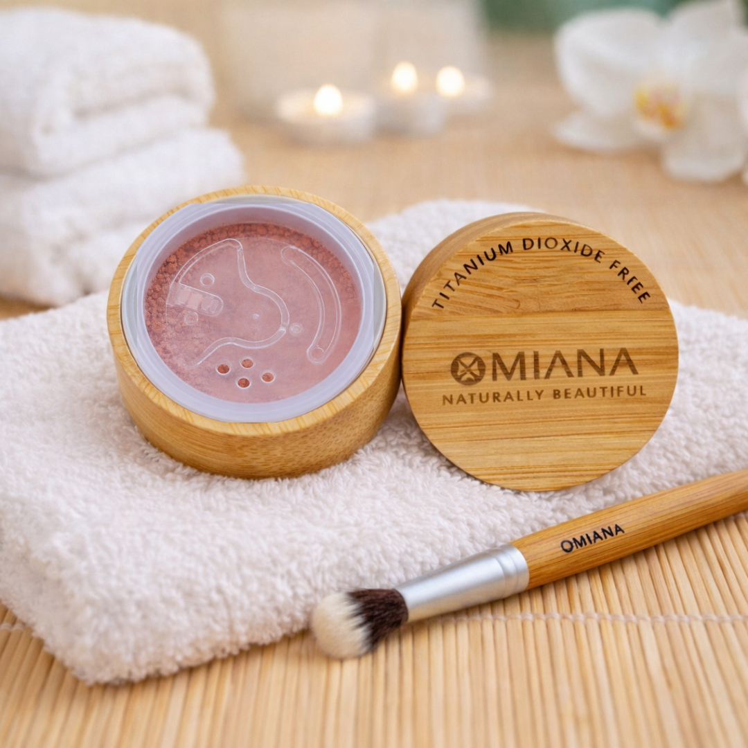 Omiana Loose Powder  Titanium Dioxide-Free Mineral Eyeshadow with wooden lid and brush on a bamboo mat